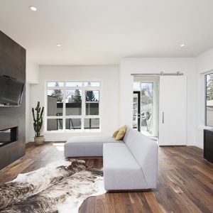 A beautiful interior shot of a modern house with white relaxing walls and furniture and technology